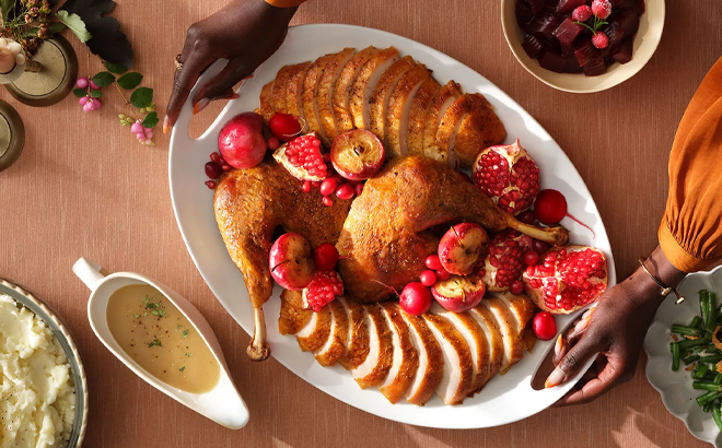 A Woman Serving the Thanksgiving Dinner on a Table