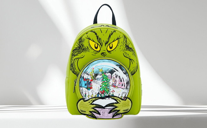 Loungefly Grinch Glow In The Dark Mini Backpack on a Table Loungefly Grinch Glow In The Dark Mini Backpack on a Table