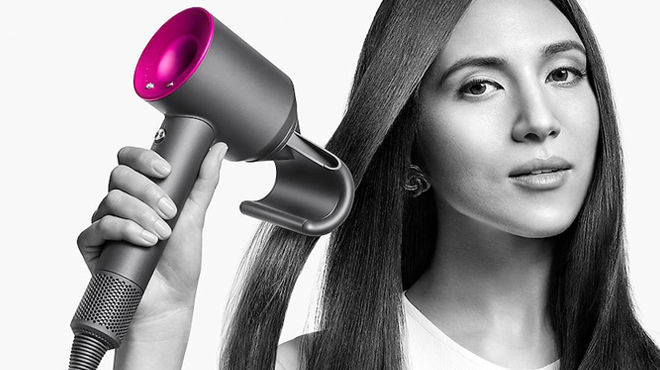 A Person drying their Hair with Dyson Supersonic Hair Dryer A Person drying their Hair with Dyson Supersonic Hair Dryer