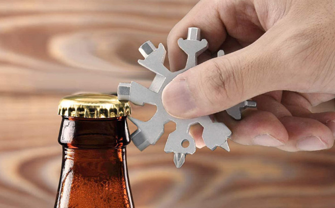 A Person Opening a Bottle Using a Snowflake Multitool