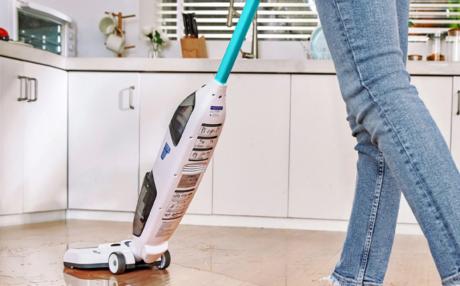 A Person Using the Tineco iFloor 2 Blue Cordless Wet Dry Vacuum A Person Using the Tineco iFloor 2 Blue Cordless Wet Dry Vacuum