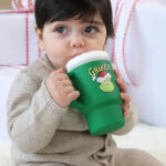 A Toddler Drinking from the Infantino Green Grinch Limited Edition My 1st Tumbler