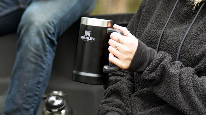 A Woman Holding Stanley Adventure Big Grip Beer Stein A Woman Holding Stanley Adventure Big Grip Beer Stein