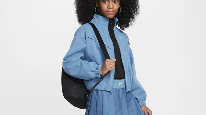 A girl wearing a Nike Girls Oversized Lightweight Jacket A girl wearing a Nike Girls Oversized Lightweight Jacket