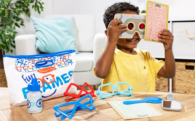 A Little Boy Playing with Melissa and Doug Fun Frames Eye Exam Pretend Play Set