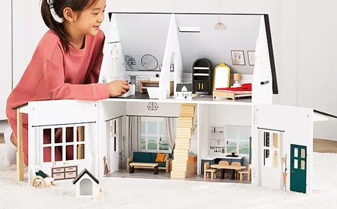 A Little Girl Playing with Members Mark Wooden Farmstyle Dollhouse