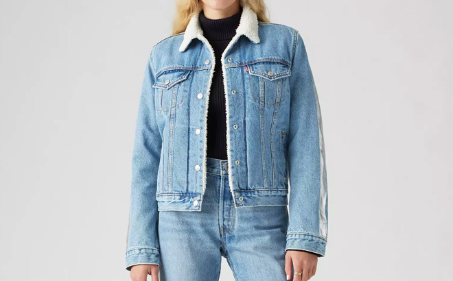 A Person Wearing Levis Original Sherpa Trucker Jacket in Medium Wash A Person Wearing Levis Original Sherpa Trucker Jacket in Medium Wash