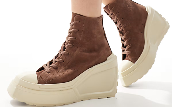 A Woman Wearing Converse Chuck 70 De Luxe Wedge Platform Hi Top Sneakers A Woman Wearing Converse Chuck 70 De Luxe Wedge Platform Hi Top Sneakers