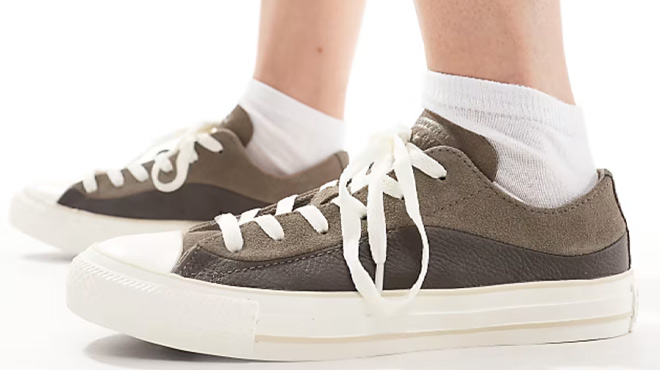 A Woman Wearing Converse Chuck Taylor All Star Sneakers A Woman Wearing Converse Chuck Taylor All Star Sneakers