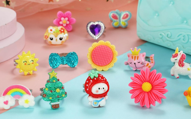 PinkSheep Little Girl Jewel Rings on the Table PinkSheep Little Girl Jewel Rings on the Table