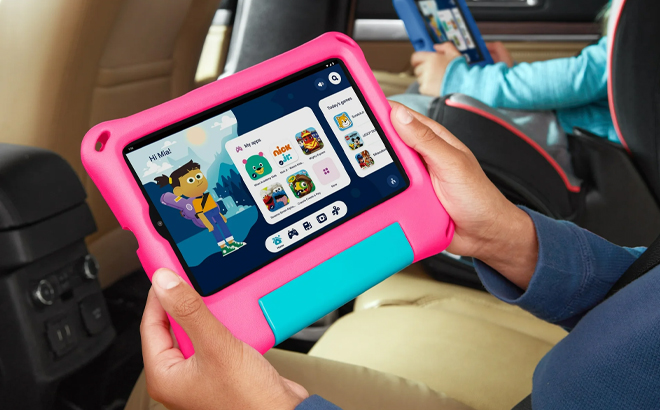 A Child Holding the onn 7 Inch Kids Tablet 2024 Model in Pink in the Car