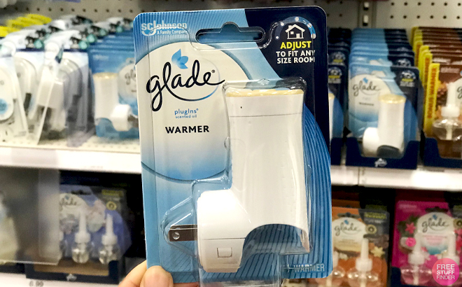 A Hand holding a Glade PlugIns Air Freshener Warmer