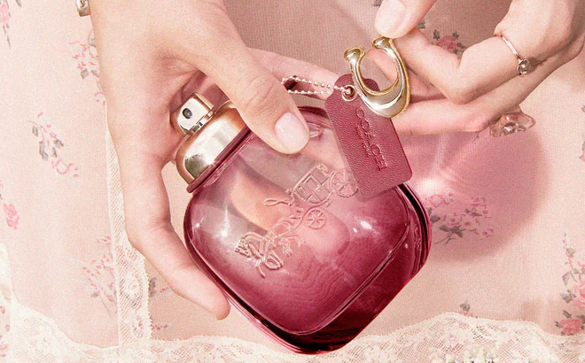 A Person Holding Coach Wild Rose Eau de Parfum