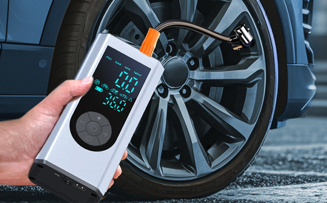A Person Holding Tire Inflator Portable Air Compressor