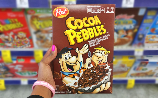 A Person Holding a Box of Post Cocoa Pebbles Cereal