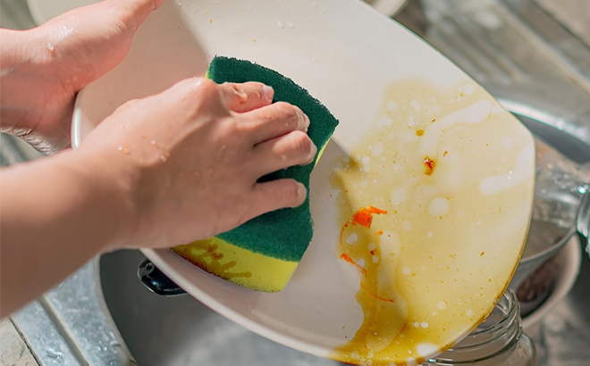 A Person Using the Kitchen Cleaning Sponge