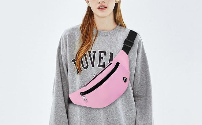 A Person Wearing Viqueen Fashion Large Fanny Waist Pack Crossbody Belt Bag in Pink Color