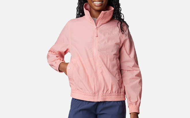 A Person wearing Columbia Womens Windbreaker Jacket in Salmon Rose Color