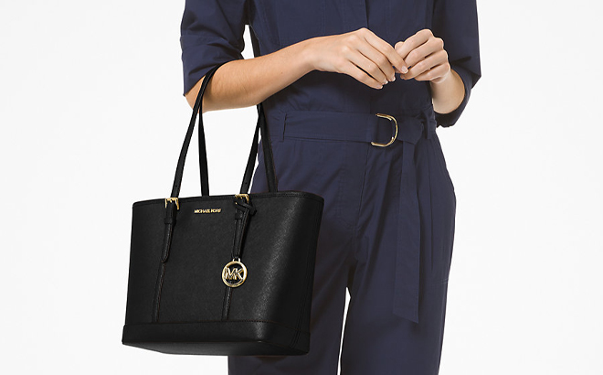 A Woman Holding Michael Kors Jet Set Travel Small Saffiano Leather Top Zip Tote Bag A Woman Holding Michael Kors Jet Set Travel Small Saffiano Leather Top Zip Tote Bag