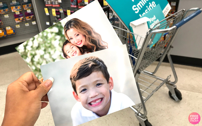 A Woman Holding Two 5x7 Photo Prints at Walgreens Store A Woman Holding Two 5x7 Photo Prints at Walgreens Store