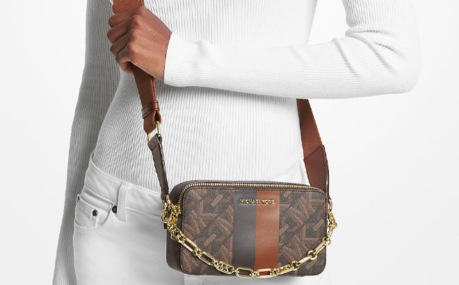 A Woman Wearing Michael Kors Jet Set Small Empire Signature Logo Stripe Double Zip Camera Bag A Woman Wearing Michael Kors Jet Set Small Empire Signature Logo Stripe Double Zip Camera Bag