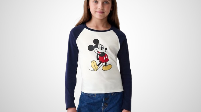 A girl wearing a GAP × Disney Kids Mickey Mouse Raglan T Shirt