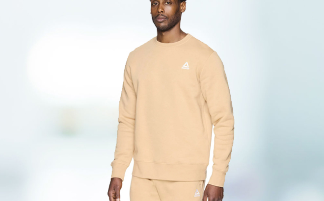 A man wearing a Reebok Mens Crewneck Sweatshirt