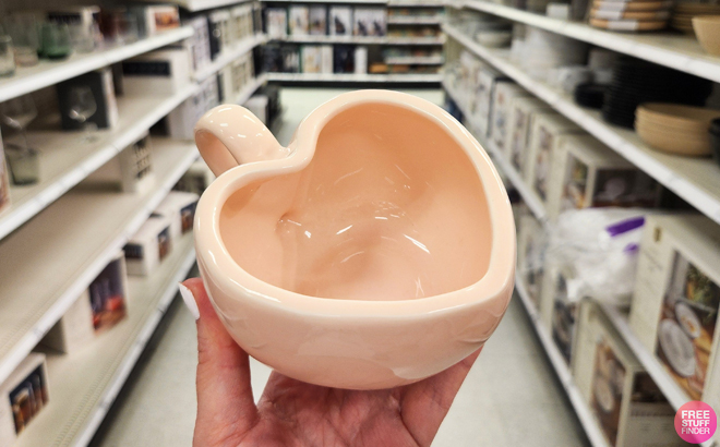 A person holding a Threshold 9 oz Stoneware Figural Latte Heart Mug A person holding a Threshold 9 oz Stoneware Figural Latte Heart Mug