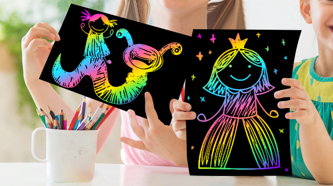 Hands holding Rainbow Scratch Papers