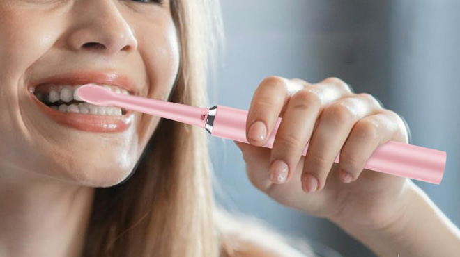 Lady using Oralexis Electric Toothbrush