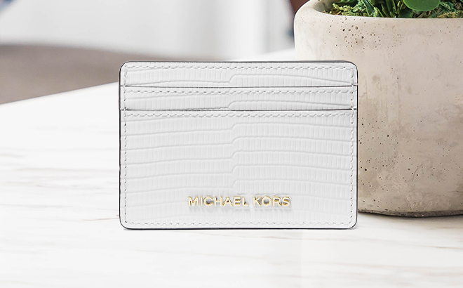 Michael Kors Jet Set Lizard Embossed Leather Card Case on a Table