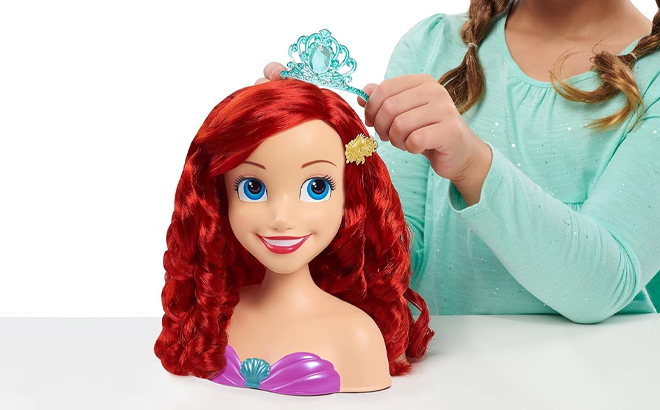 A Girl Playing with the Disney Princess Ariel Styling Head A Girl Playing with the Disney Princess Ariel Styling Head
