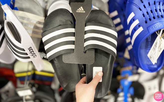 A Person Holding Adidas Adilette Aqua Slides