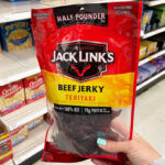 A Person Holding Jack Links Beef Jerky Teriyaki Half Pounder Bag