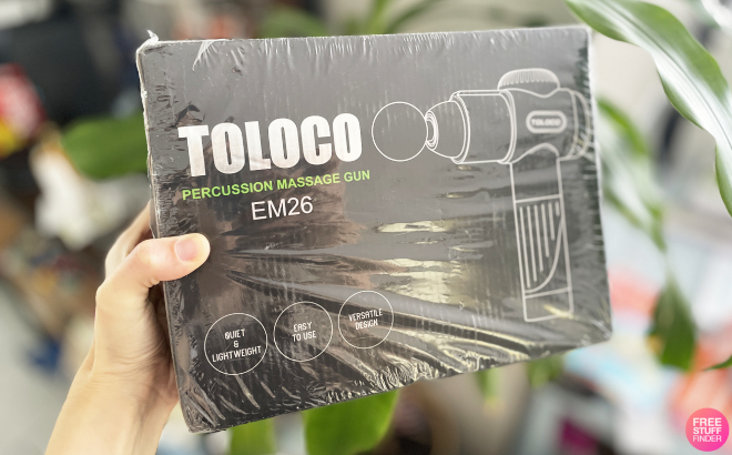 A Person Holding a Box Containing Toloco Deep Tissue Massage Gun