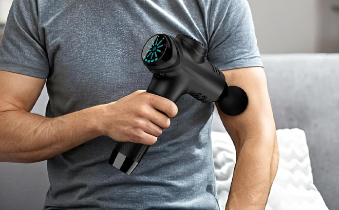 A Person Using the Raemao Handheld Electric Deep Tissue Muscle Massager