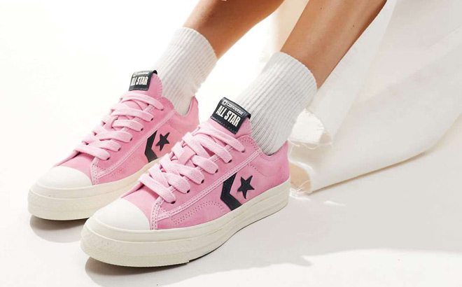 A Person Wearing Converse Star Player 76 Shoes in Pink