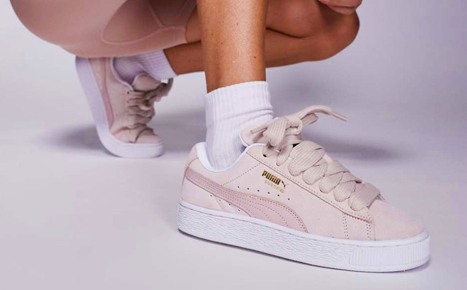 A Person Wearing Puma Suede XL Sneakers in Light Pink