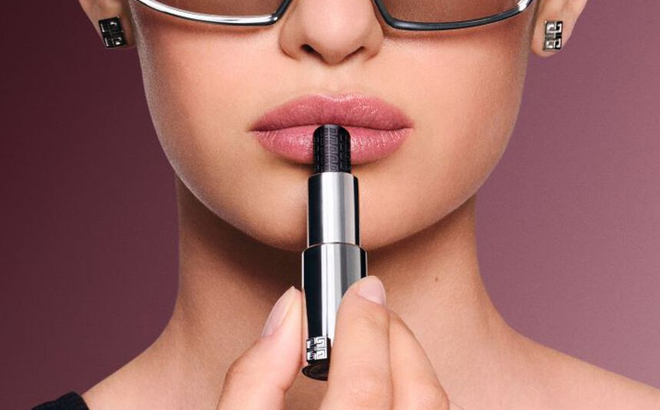 A Person applying Givenchy Le Rouge Interdit Black Magic Lip Balm on their Lips