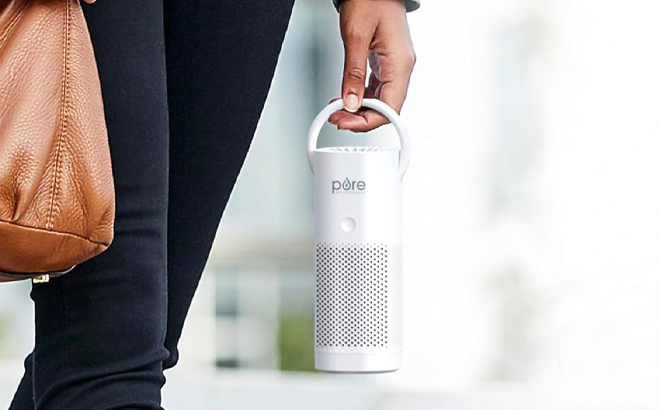 A Woman Holding Pure Enrichment Pure Zone Mini Portable HEPA Air Purifier