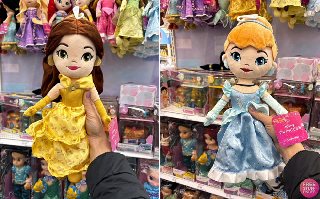 A person holding a Disney Princess Belle Signature Collection Plush on the left and Disney Princess Cinderella Signature Collection Plush on the right A person holding a Disney Princess Belle Signature Collection Plush on the left and Disney Princess Cinderella Signature Collection Plush on the right