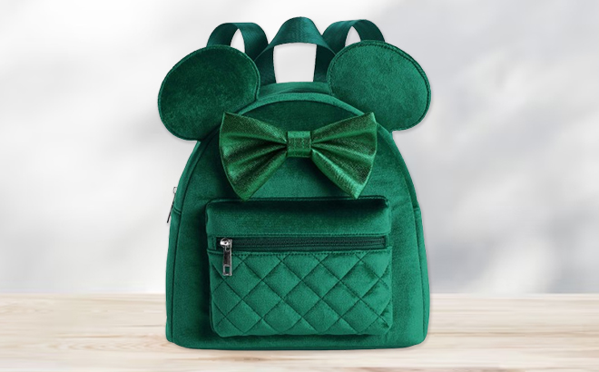 Disneys Minnie Mouse Velvet 3D Ears & Bow Mini Backpack on a Table