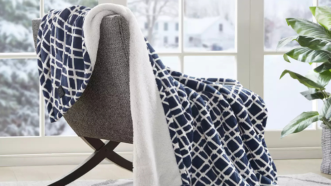 Serta Plush To Sherpa Heated Electric Throw Blanket on an Armchair
