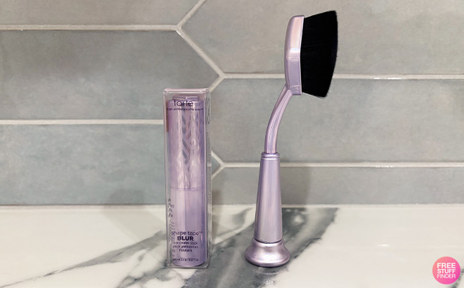 Tarte Concealer next to a Brush