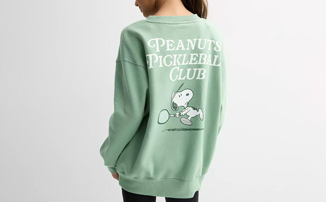 A Kid Wearing Licensed Character Girls Peanuts Snoopy Pickleball Club Fleece Sweatshirt A Kid Wearing Licensed Character Girls Peanuts Snoopy Pickleball Club Fleece Sweatshirt