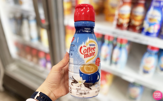 A Person Holding a Bottle of Coffee Mate French Vanilla Coffee Creamer A Person Holding a Bottle of Coffee Mate French Vanilla Coffee Creamer
