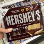 A Person Holding a Pack of Hersheys Milk Chocolate Candy Bars