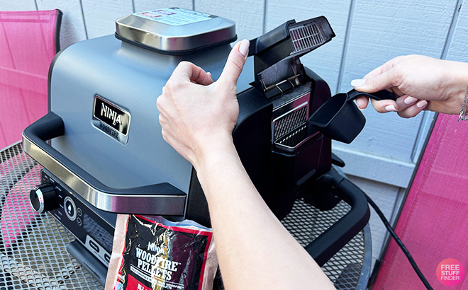 A Person Setting Up a Grill A Person Setting Up a Grill