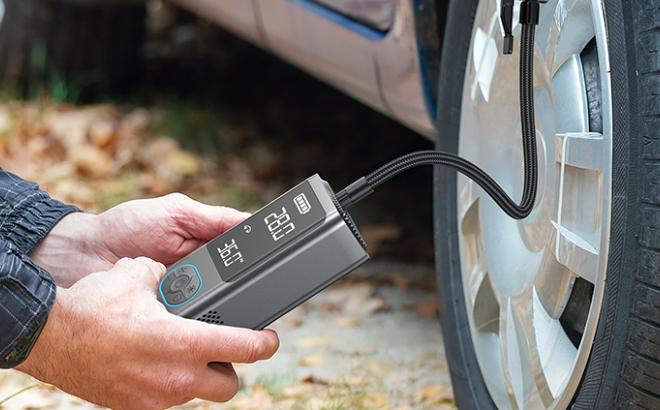 A Person Using an Avapow Portable Tire Inflator