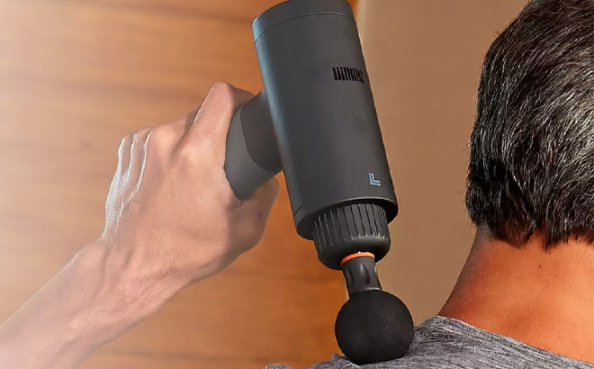 A Person Using the Sharper Image Powerboost Deep Tissue Percussion Massager
